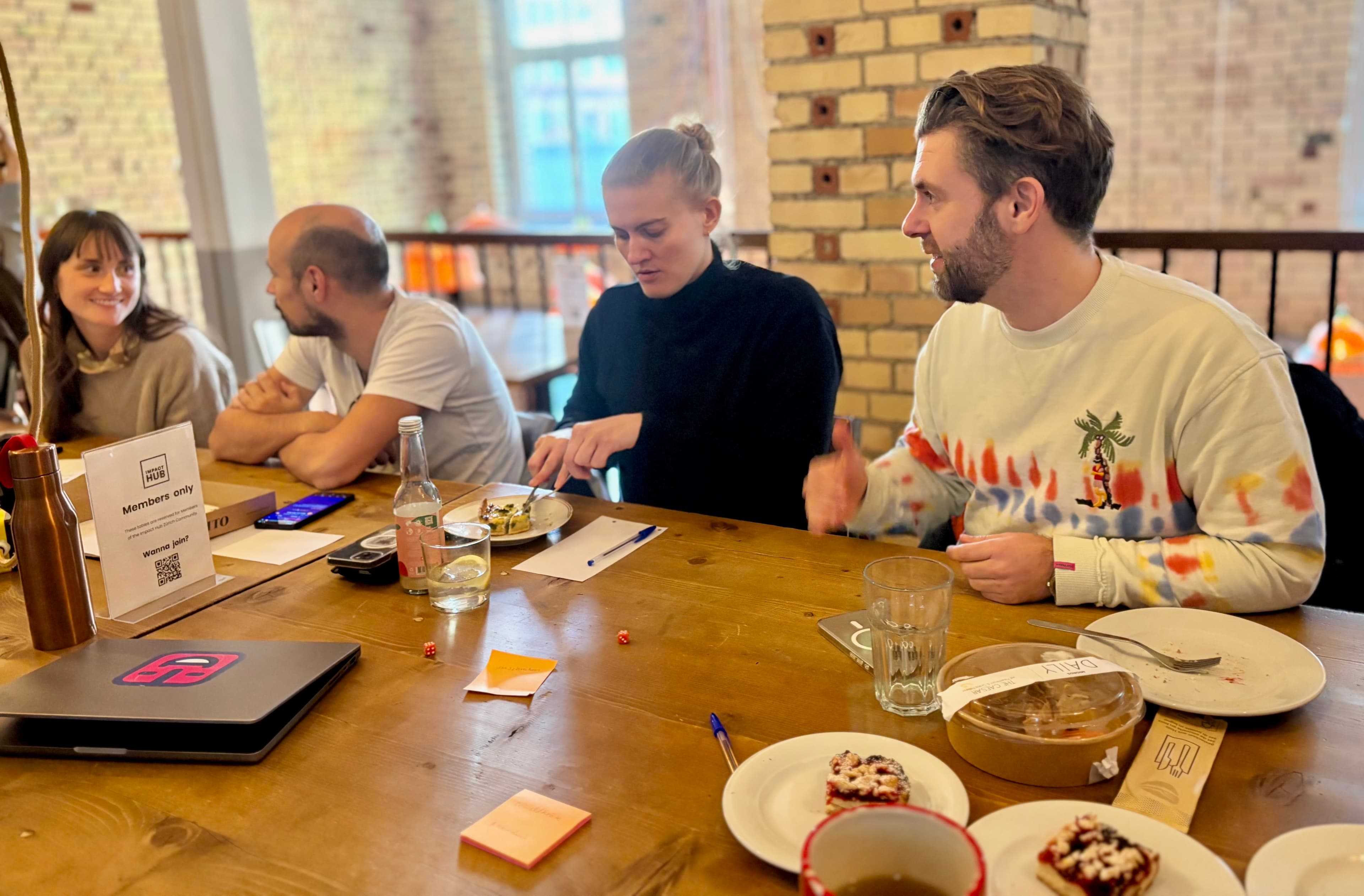 Team members engaging in language exchange during lunch